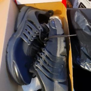 Kids black nike sneakers